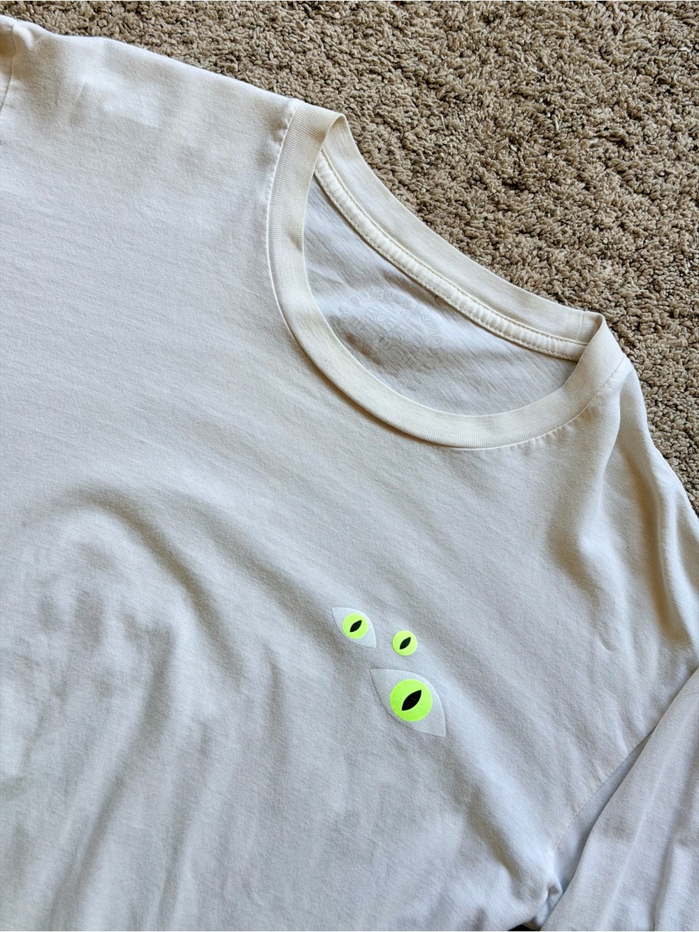 Invisible Creature Men's White Spooky Graphic Long Sleeve Tee with Neon Eyes